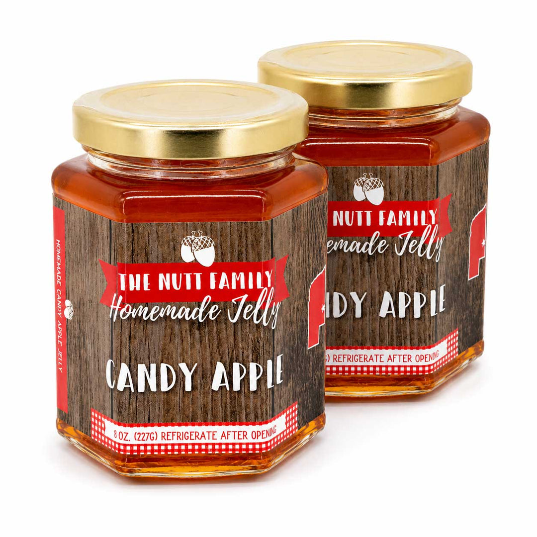 Two jars of 'Nutt Family Homemade Jelly Candy Apple' on a white background