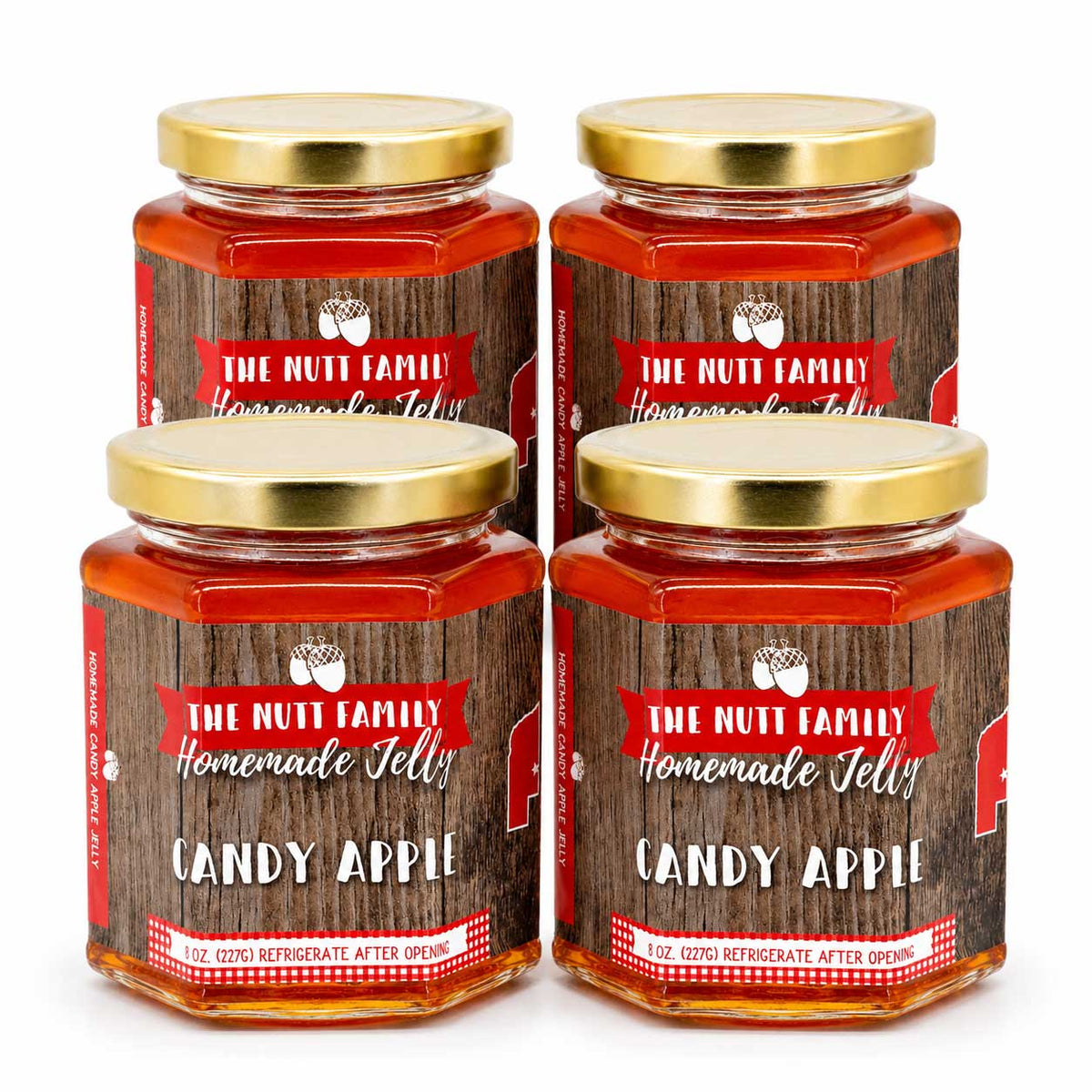 Four jars of The Nutt Family Candy Apple Jelly on a white background