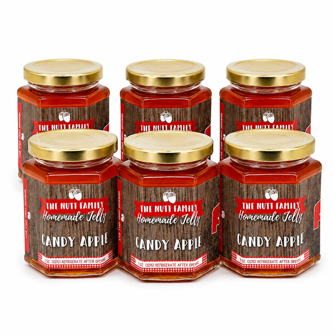 Six jars of Candy Apple jelly from The Nutt Family on a white background