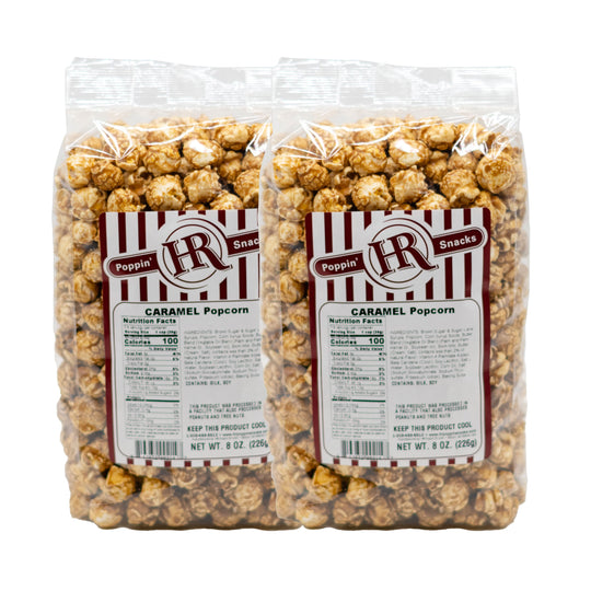 Two packages of caramel popcorn with labels on a white background