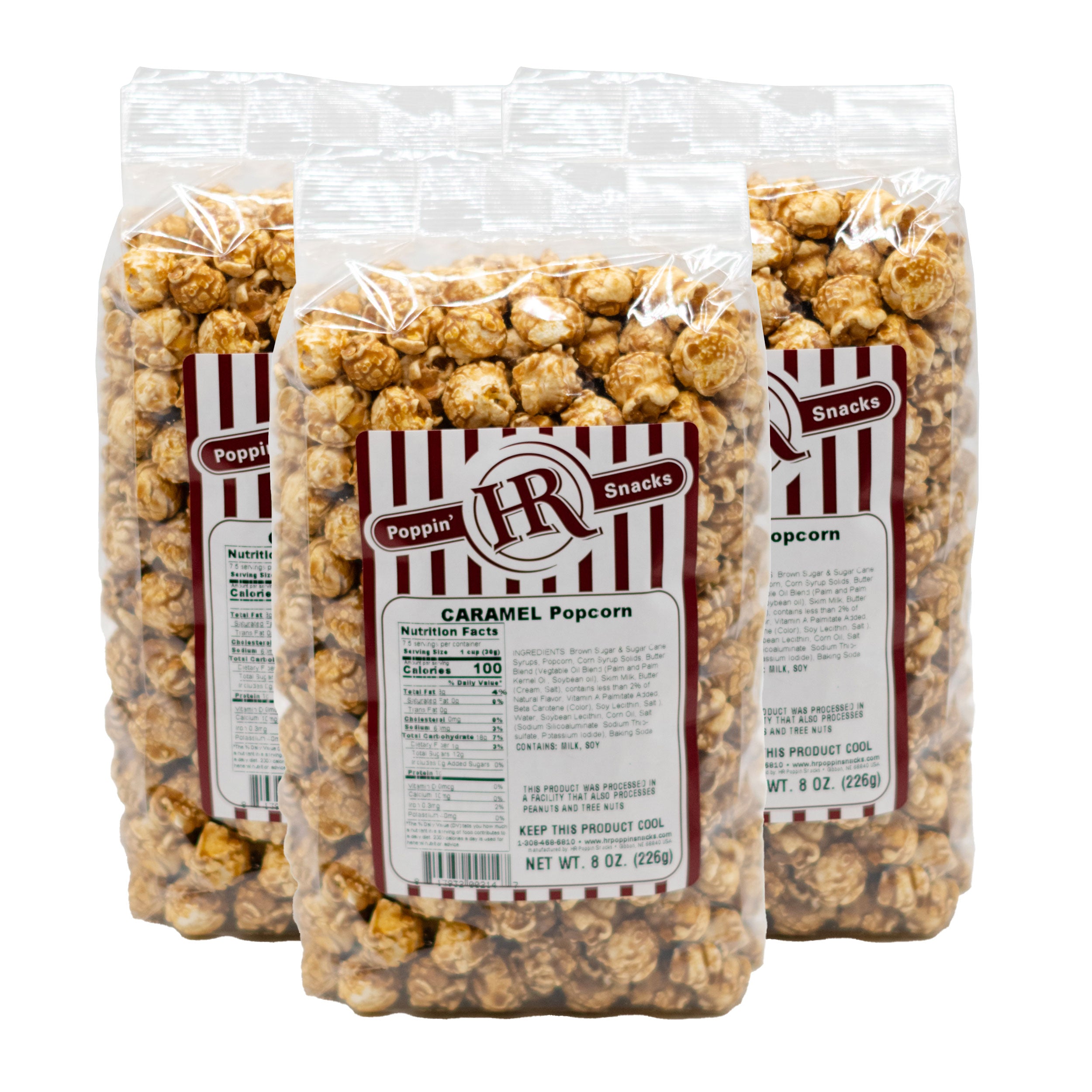 Three bags of Poppin' Corn caramel popcorn with visible labels on a white background