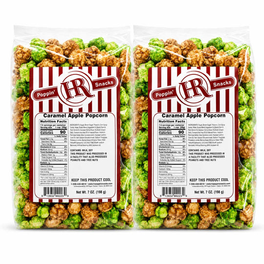 Two clear bags of Poppin' HR Snacks Caramel Apple Popcorn shown side by side on a white background, with green-topped caramel apple pieces and brown caramel-coated pieces visible through the packaging.