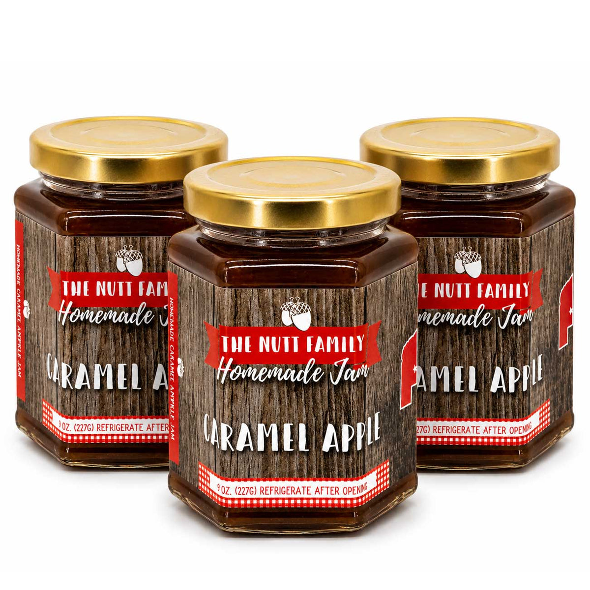 Three jars of 'The Nutt Family Homemade Caramel Apple Jam' with gold lids on a white background.