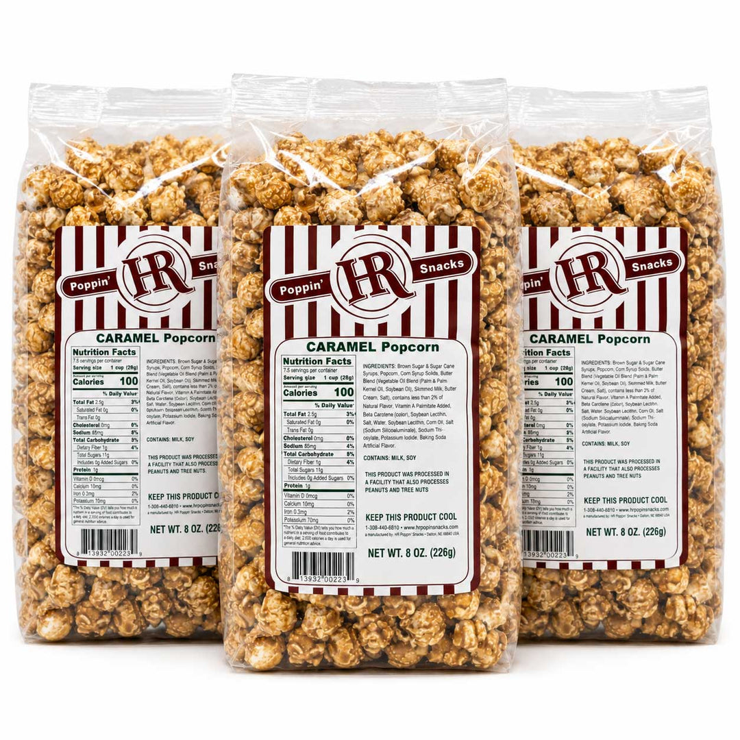 Three clear plastic bags of Pepperoni Caramel Popcorn arranged side by side on a white background, showing the product and labels in detail.