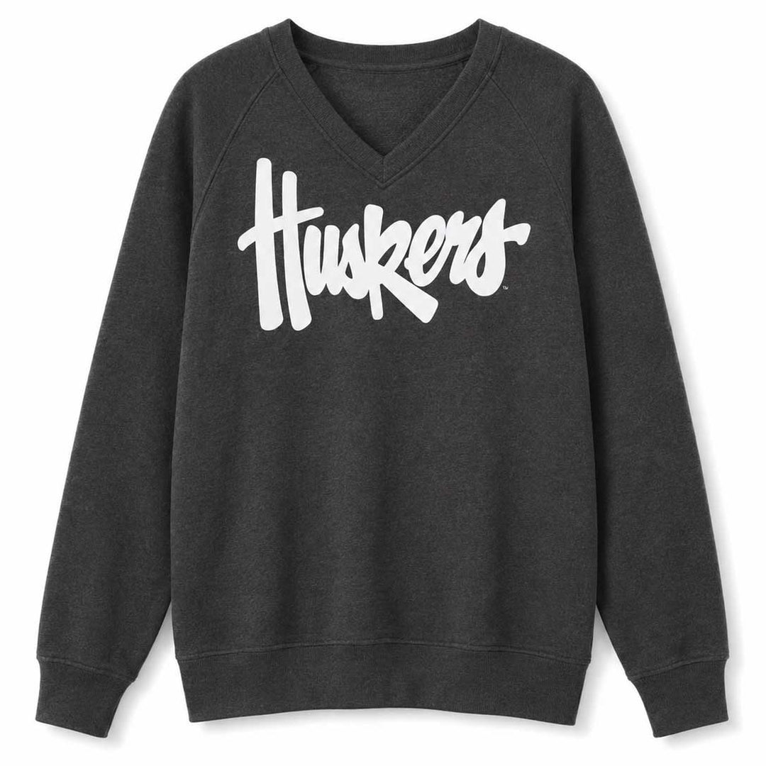 A dark charcoal gray V-neck sweatshirt with the word 'Huskers' printed across the chest in a large white script font, shown against a plain white background.