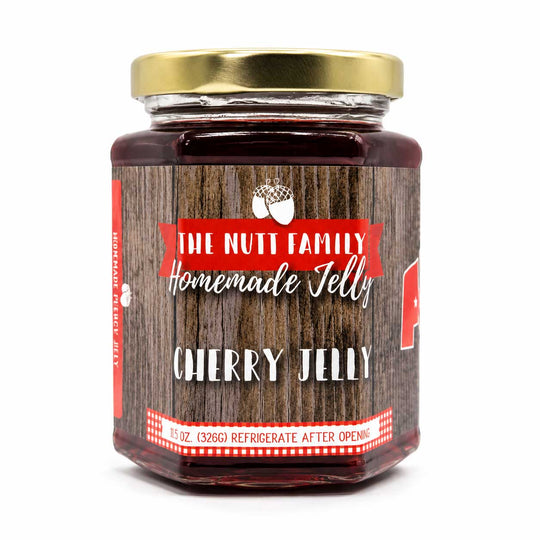 Jar of cherry jelly with a wooden label on a white background