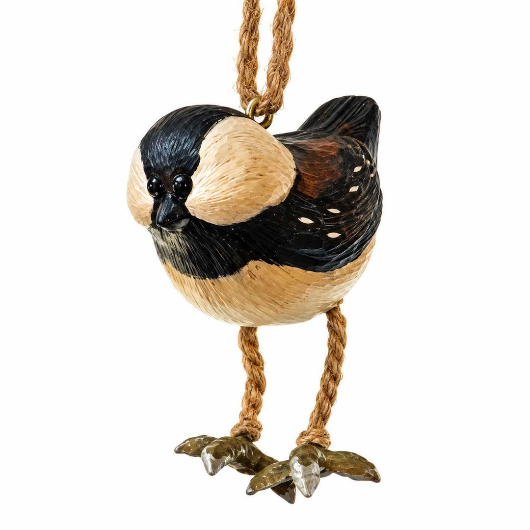A decorative bird ornament shaped like a small black, cream, and brown bird hanging from a twisted rope loop, shown on a plain white background.