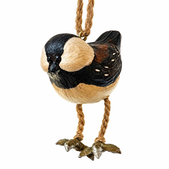 A decorative bird ornament shaped like a small black, cream, and brown bird hanging from a twisted rope loop, shown on a plain white background.
