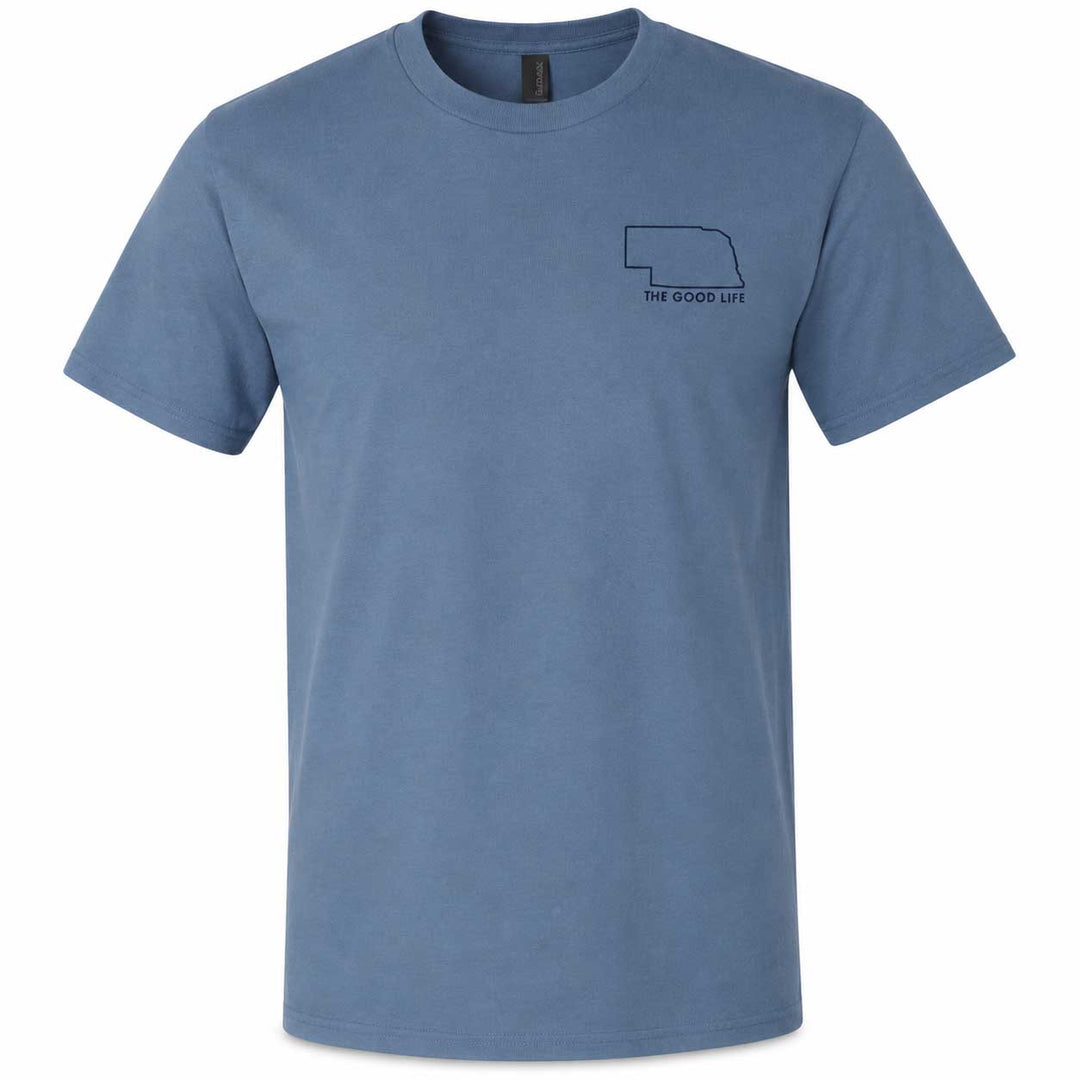 A slate blue crewneck t-shirt with a small dark navy graphic on the left chest showing the outline of Nebraska and the text 'THE GOOD UT'.