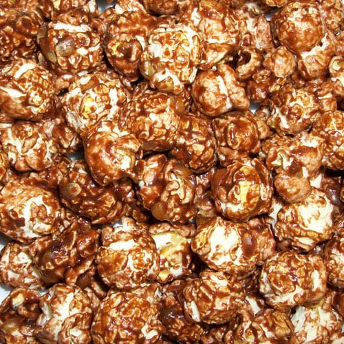 Caramel popcorn coated in glossy brown caramel, filling the entire frame.