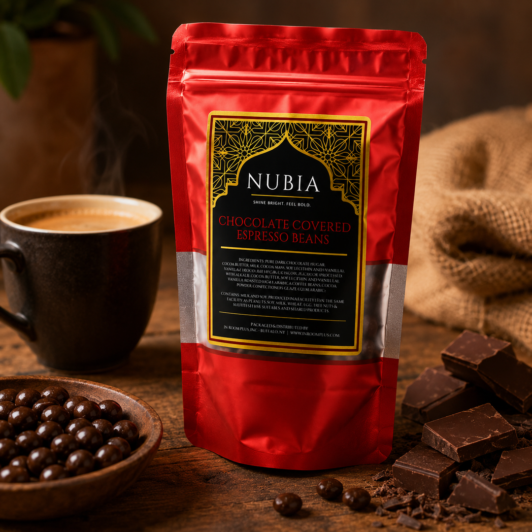 Red package of Nubia chocolate-covered espresso beans on a wooden table with coffee and chocolate.