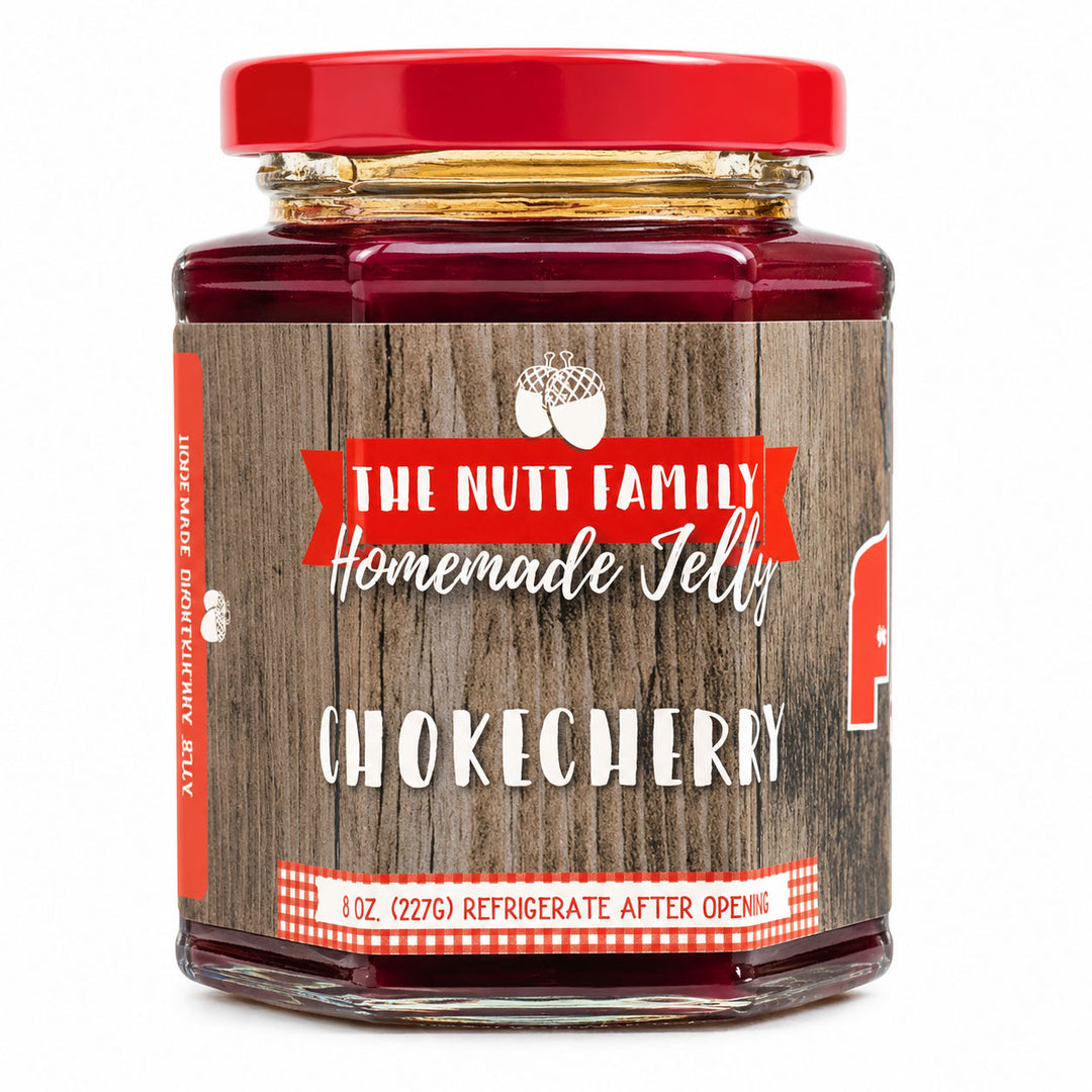 Jar of The Nutt Family Homemade Jelly with a red lid on a white background