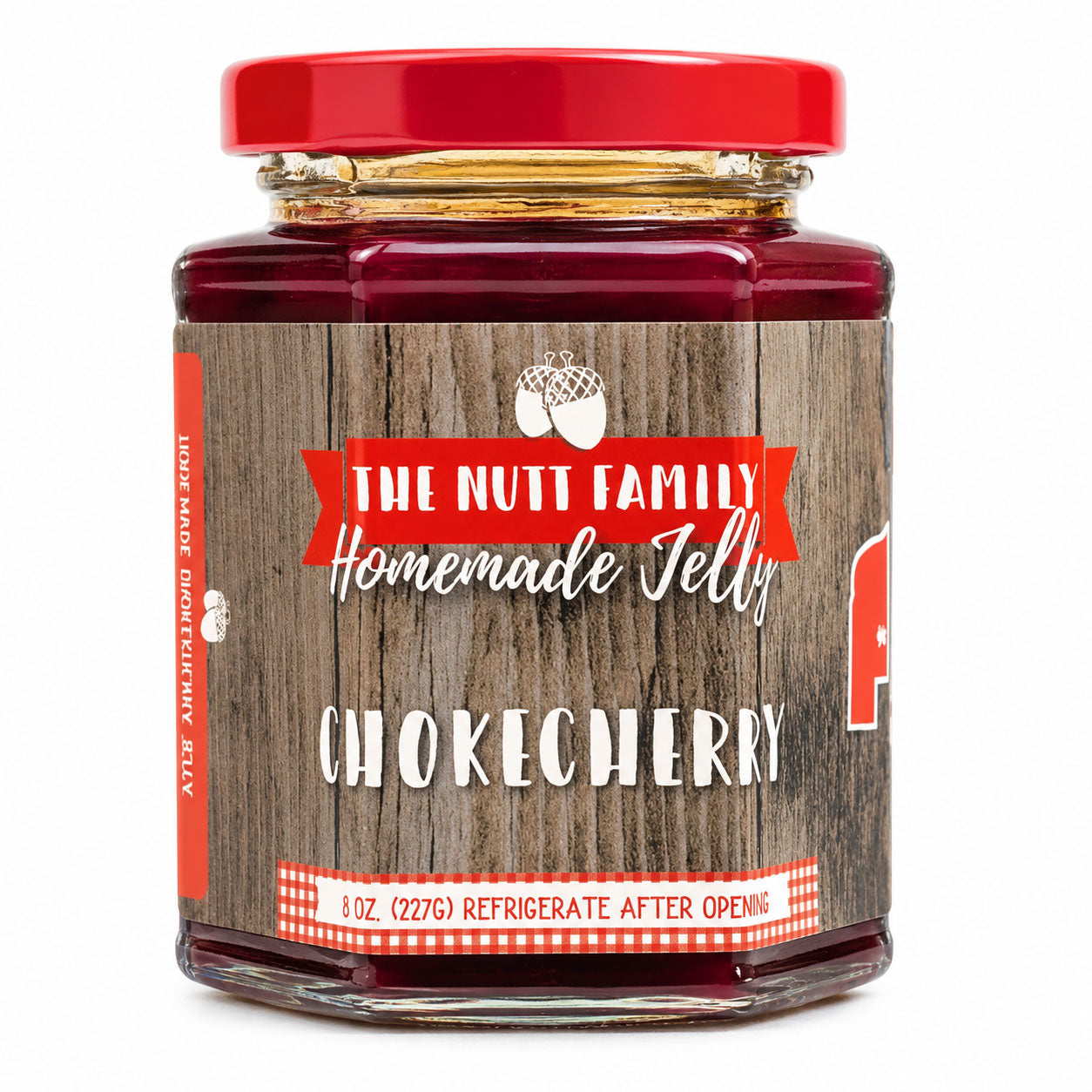 Jar of The Nutt Family Homemade Jelly with a red lid on a white background
