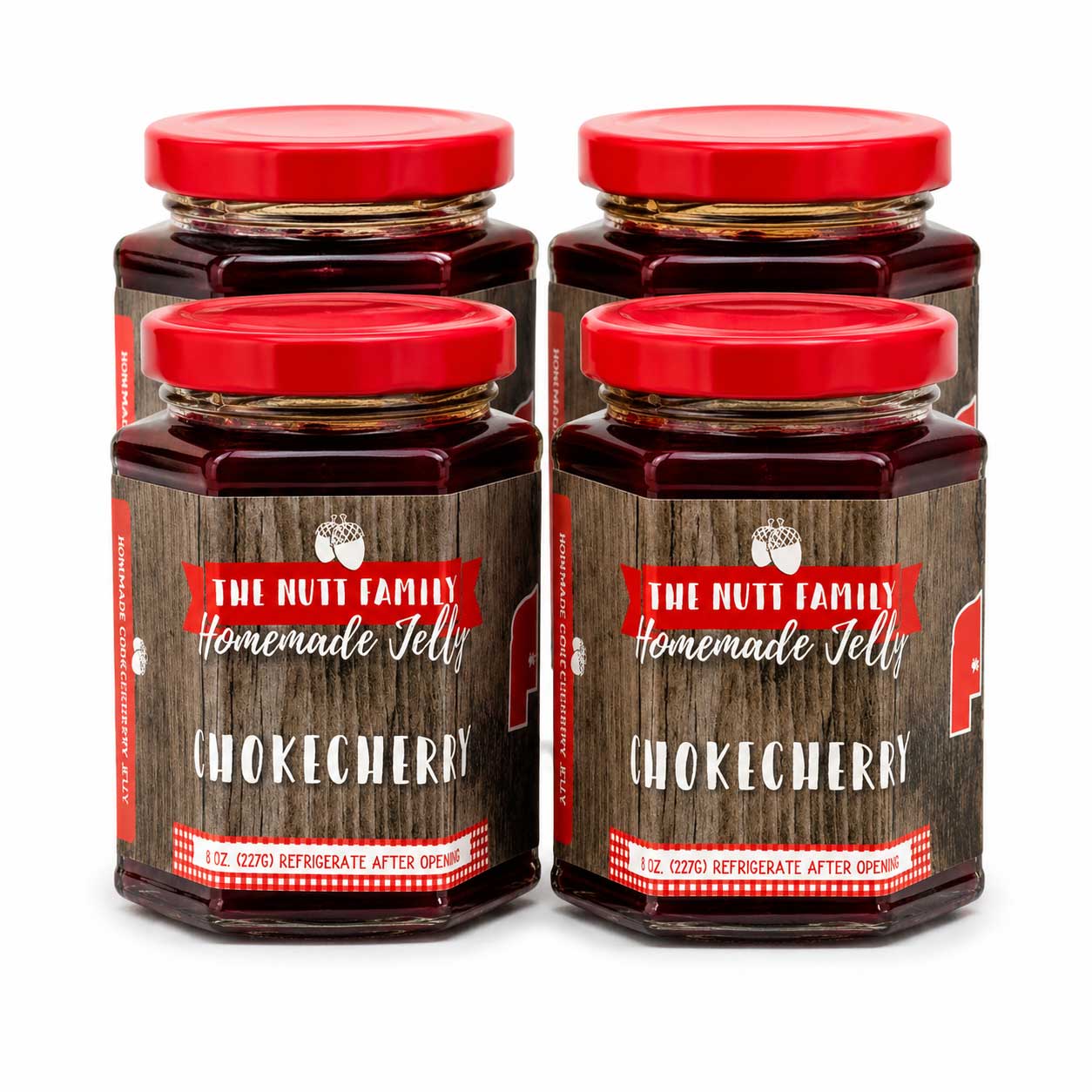 Four jars of The Nutt Family Homemade Chokecherry Jelly with red lids on a white background.