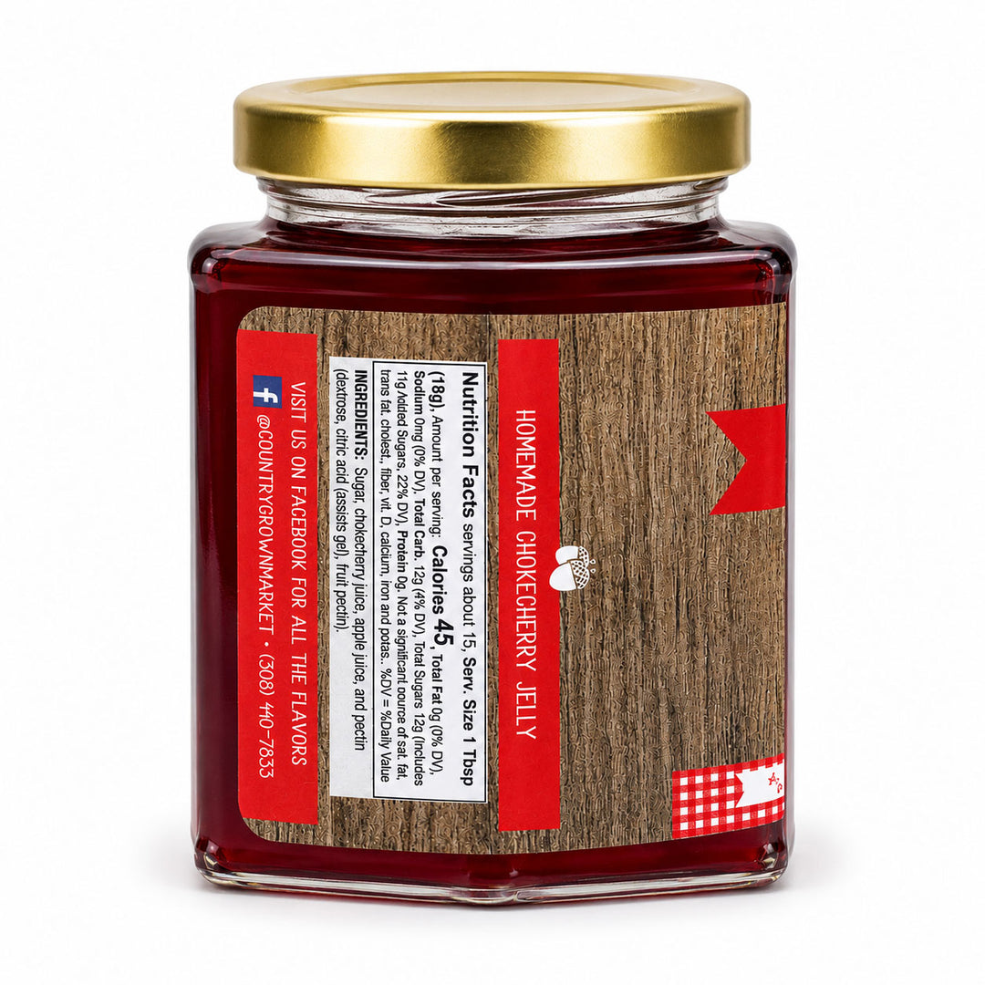 Jar of homemade cranberry cherry jelly with a gold lid on a white background