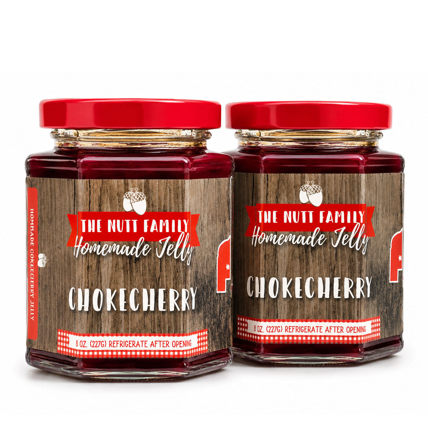 Two jars of The Nutt Family Homemade Jelly with red lids on a white background