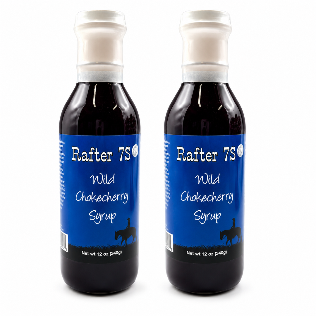 Two bottles of Rafter 7S Wild Chokecherry Syrup on a white background