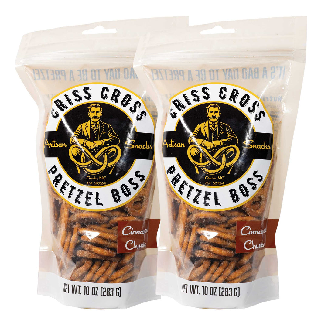 Two packages of Criss Cross Pretzel Boss Cinnamon Churro pretzels on a white background