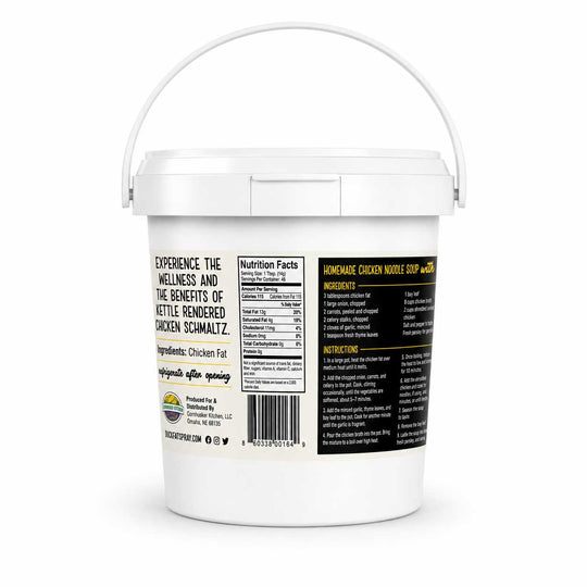 A white plastic bucket of Cornhusker Kitchen Chicken Fat shown from the back to display the nutrition facts, ingredients, and instructions on a white background.
