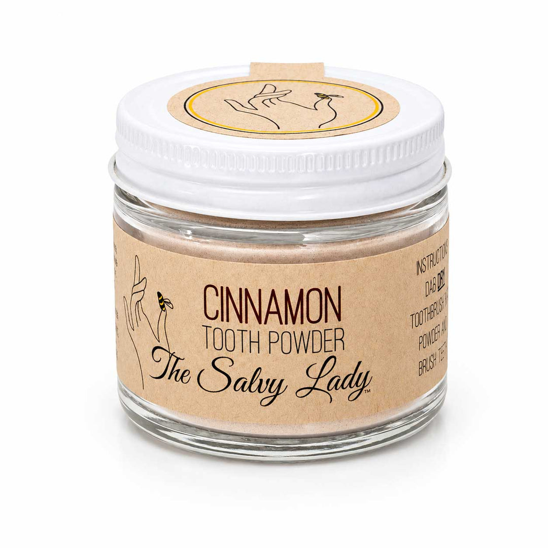 Jar of cinnamon tooth powder with 'The Salvy Lady' branding on a white background
