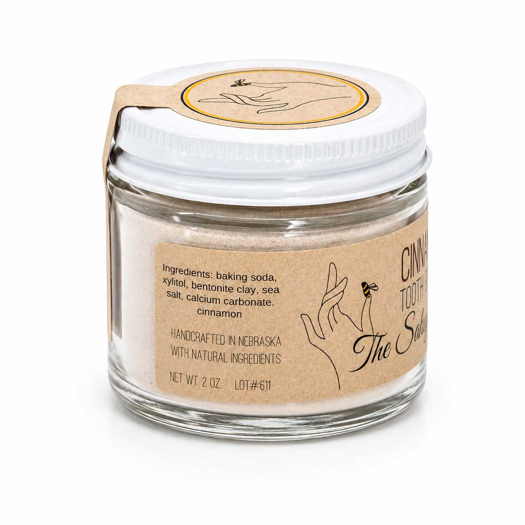 Glass jar with white lid and brown label on a white background