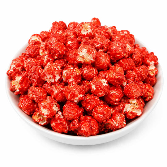 A white bowl filled with bright red popcorn coated in a glossy red glaze, photographed on a clean white background.
