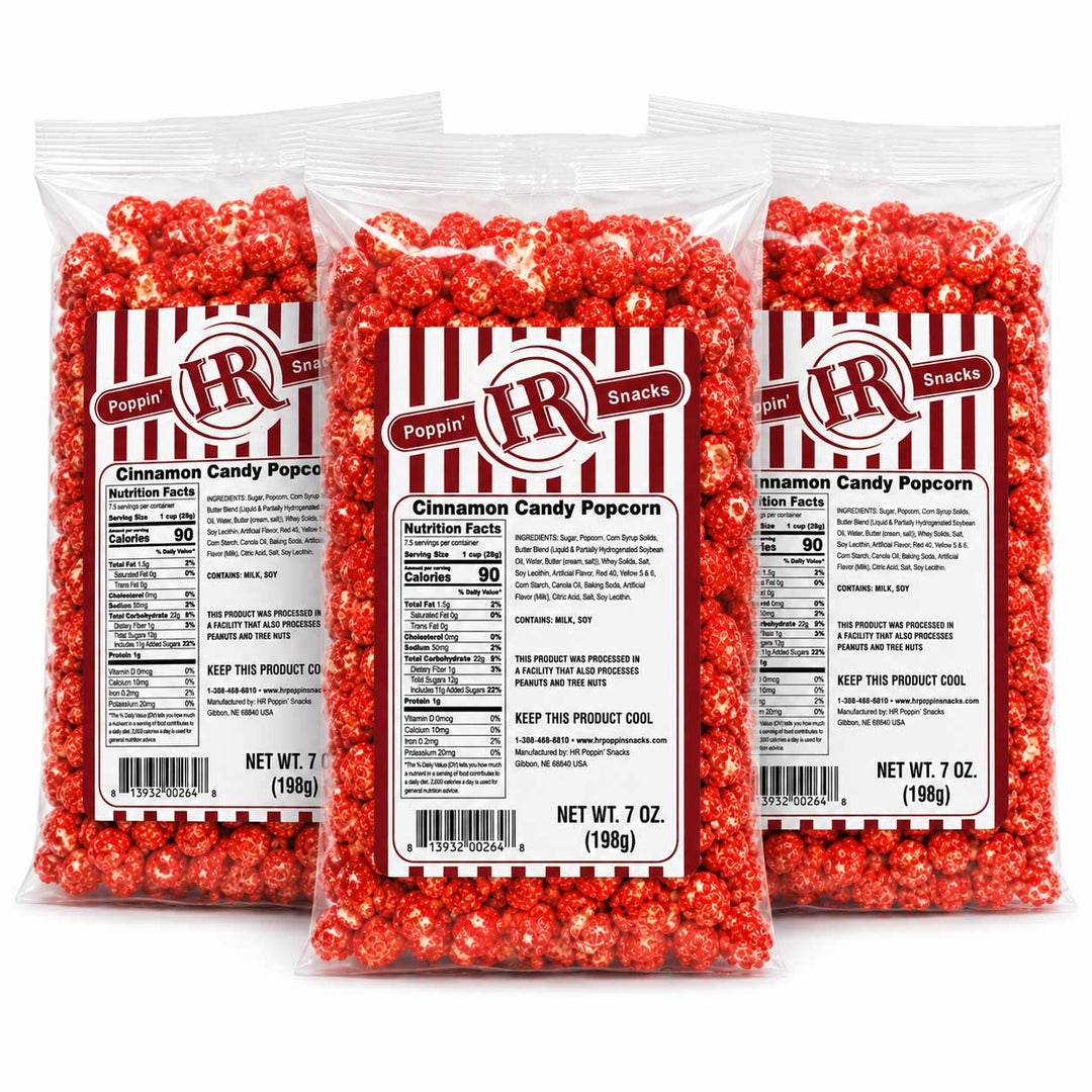 Three clear plastic bags of Poppin' R R Snacks Cinnamon Candy Popcorn arranged in a fan shape against a white background.