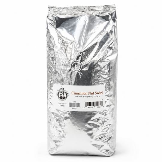 Silver bag of cinnamon nut swirl coffee on a white background