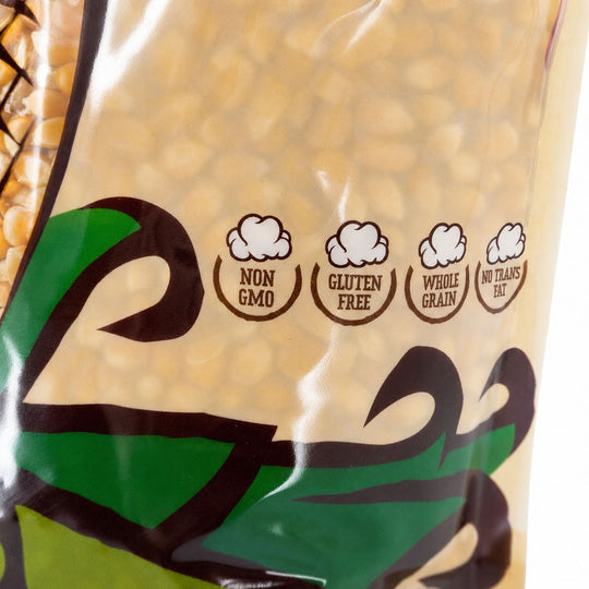 Bag of popcorn kernels with certification labels on a blurred corn background