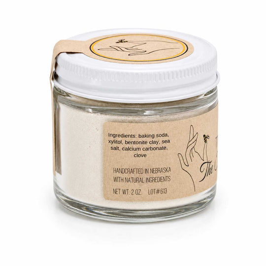 Glass jar with white lid and brown label on a white background