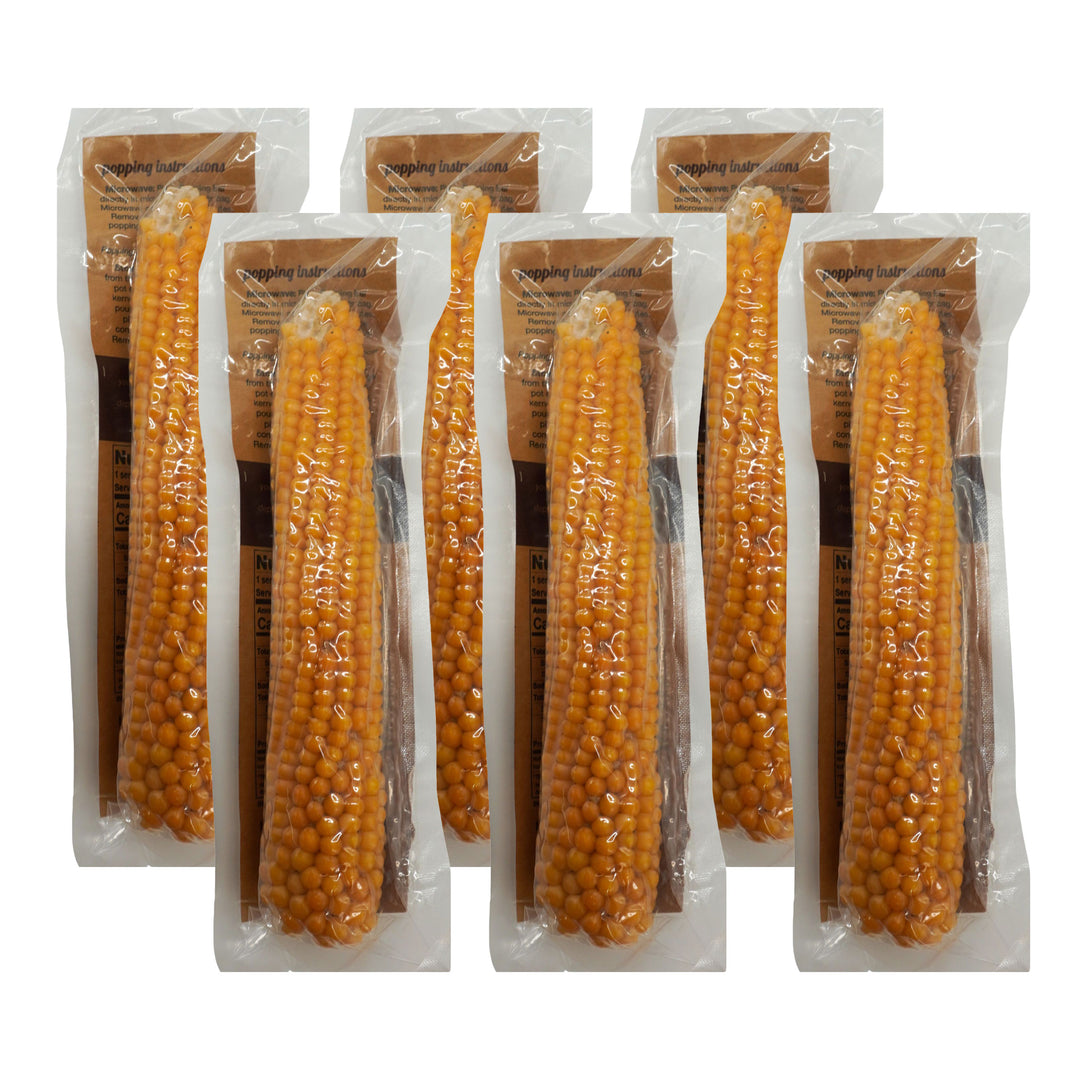 Packaged corn on the cob in clear plastic with brown labels on a white background