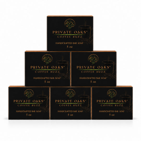 Six black boxes of Private Oaks Coffee Buzz Handcrafted Bar Soap arranged in a pyramid stack on a white background.
