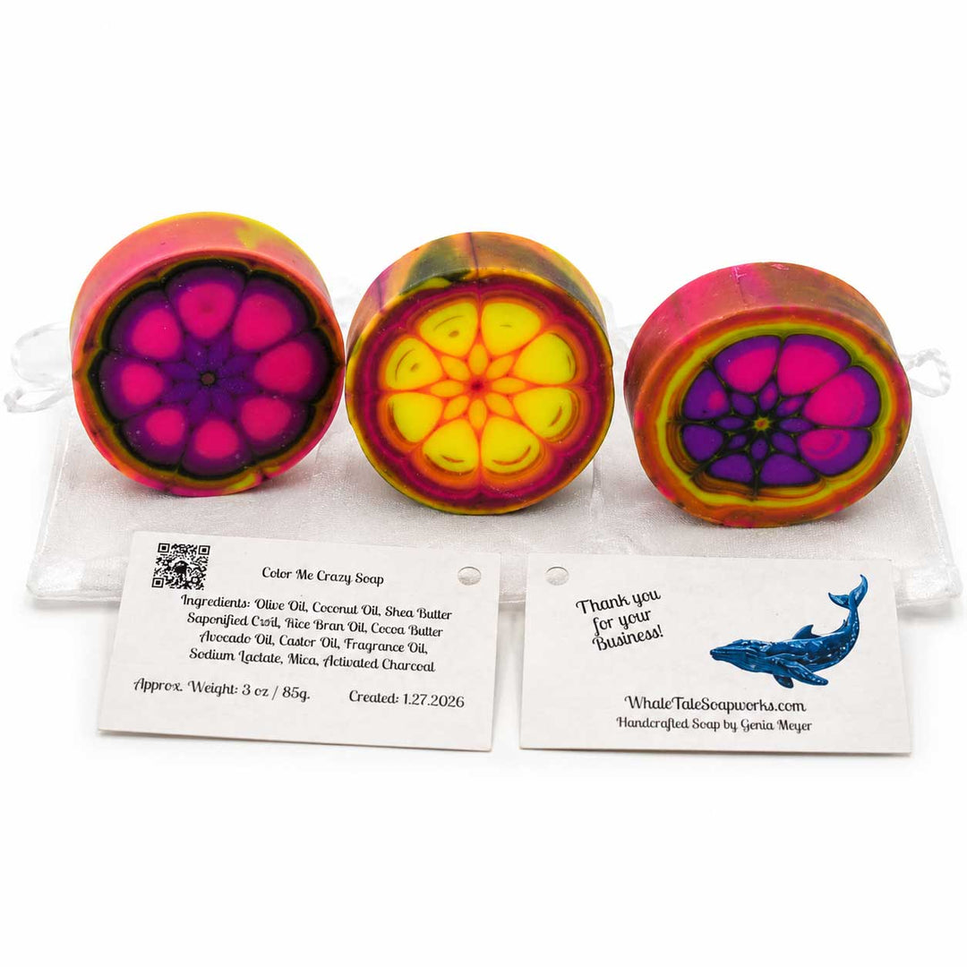 Three colorful soap bars with floral patterns on a white background, accompanied by business cards.