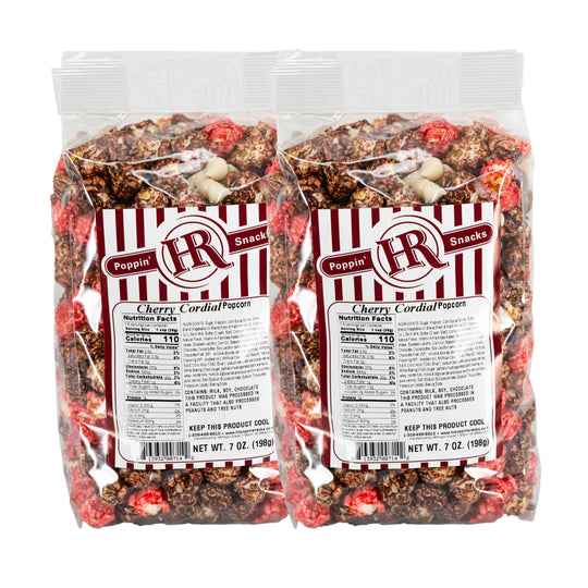 Two packages of Cherry Cordial Popcorn with visible branding and nutritional information.