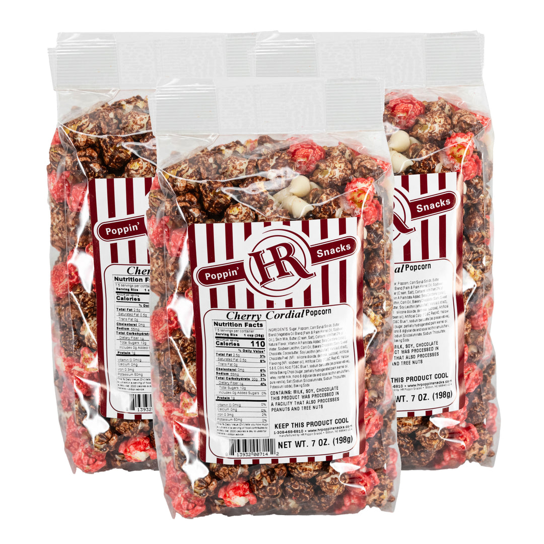 Three packages of Cherry Cordial Popcorn with visible labels on a white background