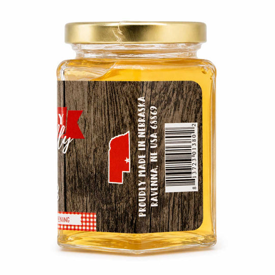 Jar of honey with a wooden label on a white background