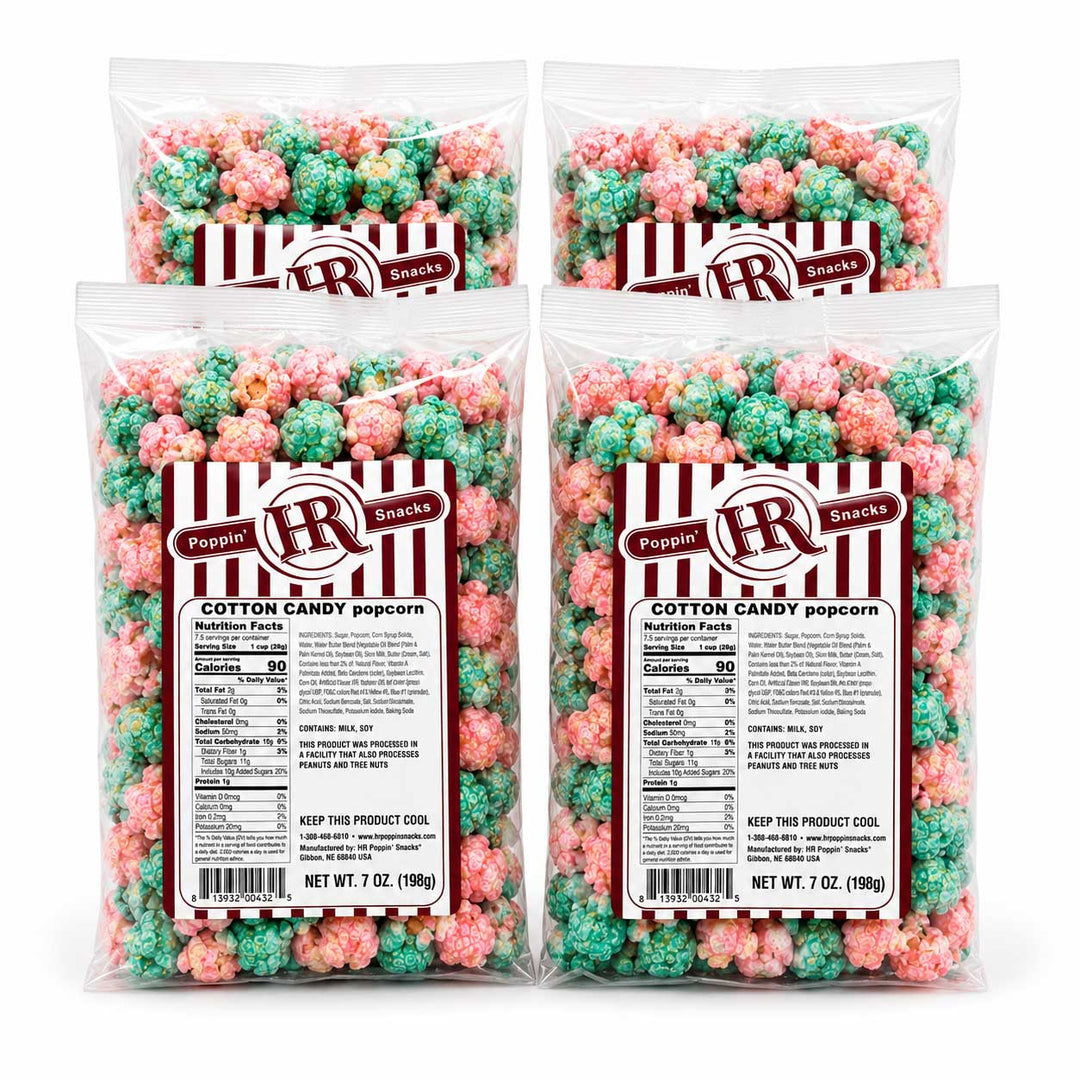 Four clear plastic bags of Poppin' Snacks Cotton Candy Popcorn arranged in a 2x2 grid on a white background. Each bag contains 7 oz (200g) of popcorn coated in pink and green candy, with a red and white striped label featuring the brand logo.