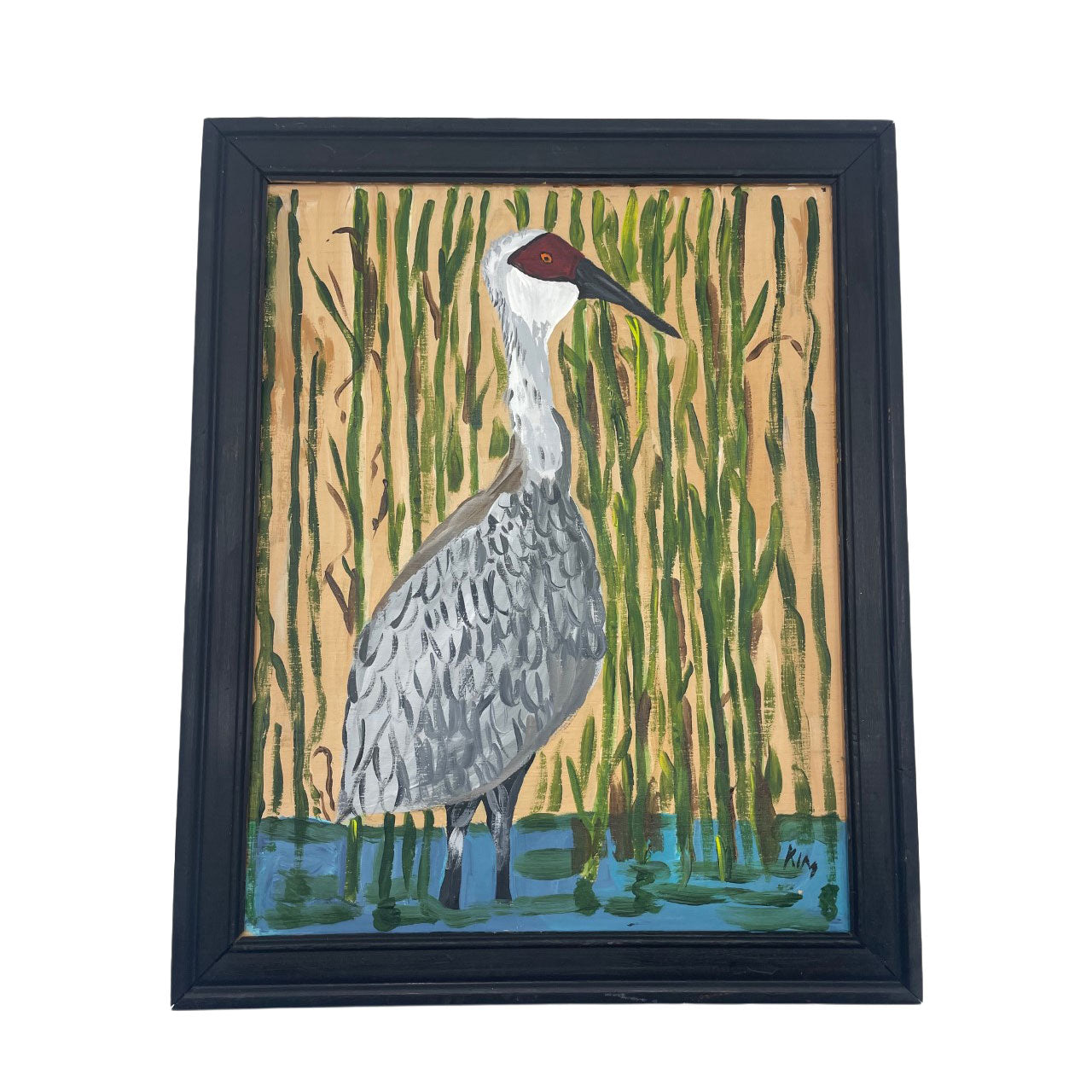 Framed artwork of a bird standing in water with reeds in the background