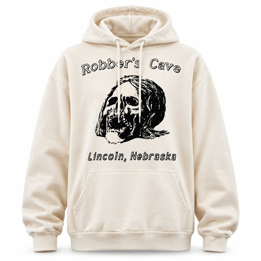 An off-white hooded sweatshirt with a black graphic print of a skull with long hair, the text 'Robber's Cave' above, and 'Lincoln, Nebraska' below, shown on a plain white background.