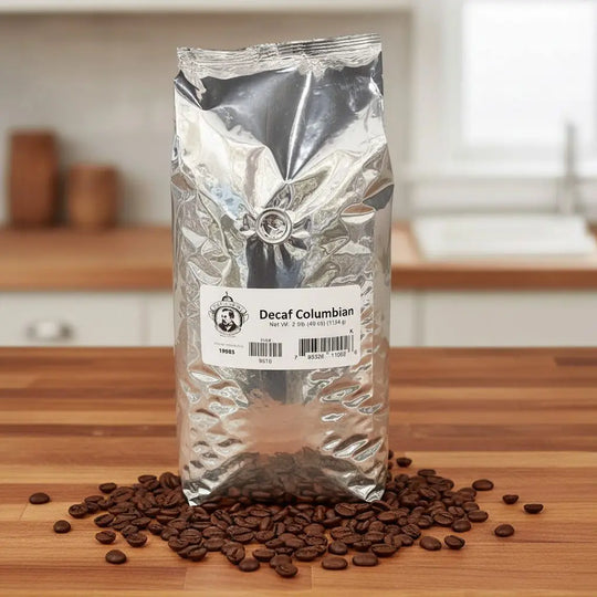 Decaf Colombian coffee package on a wooden surface with scattered coffee beans