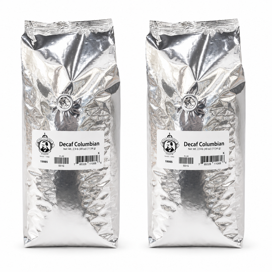 Two packages of Decaf Colombian coffee on a white background