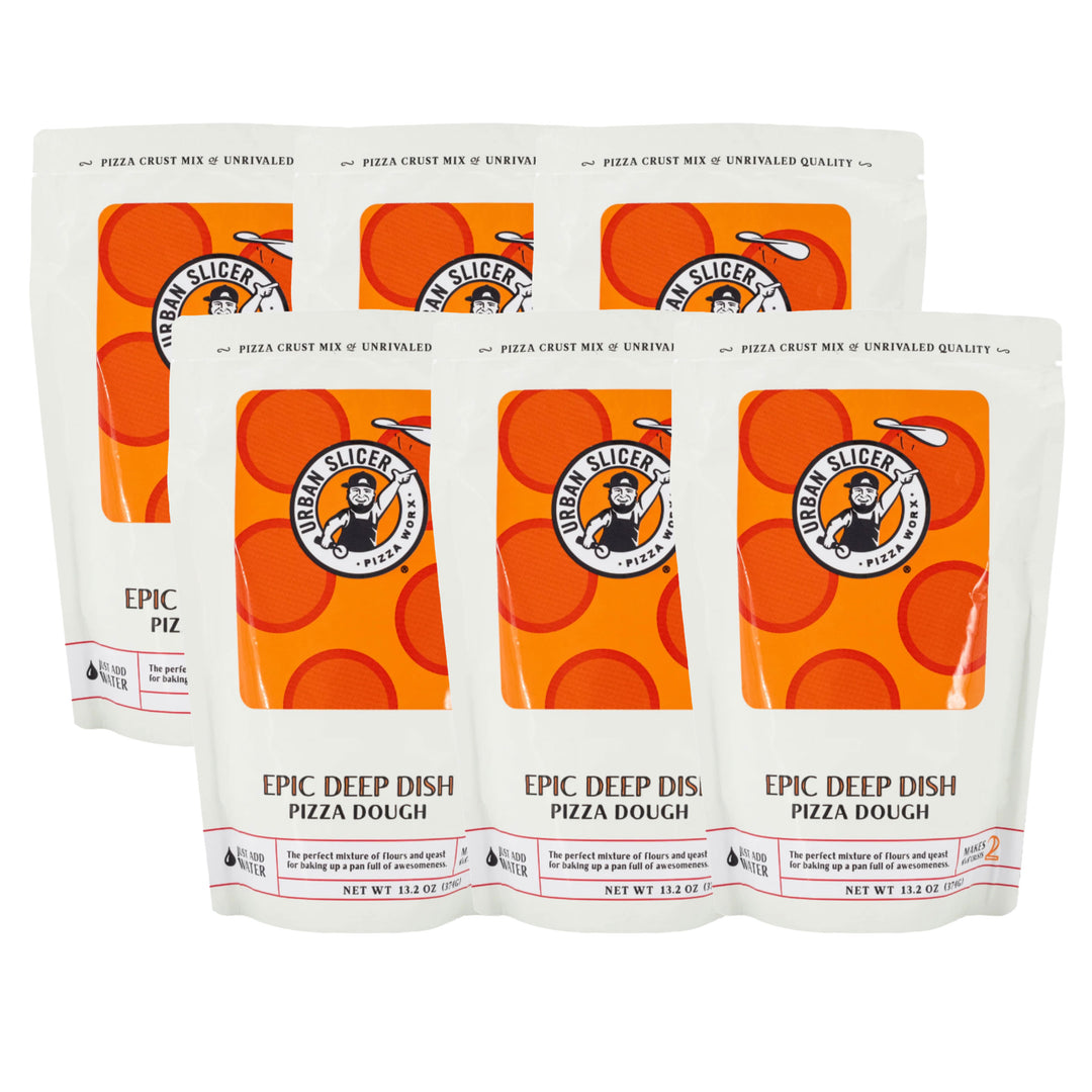 Six packages of Urban Slicers pizza dough on a white background