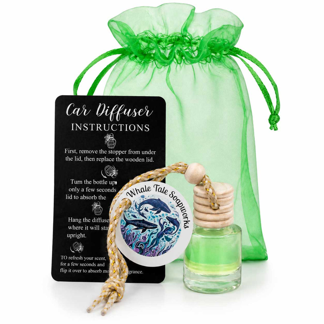 Car diffuser with whale design, bottle, and green drawstring bag on a white background