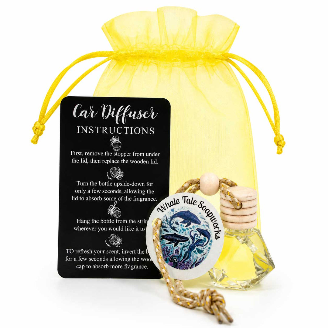 Car diffuser with instructions card and yellow drawstring bag on a white background
