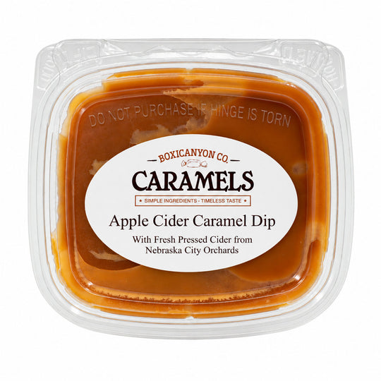 Boxicanyon Co. Apple Cider Caramel Dip in a clear plastic tub with a white oval label, photographed on a white background.