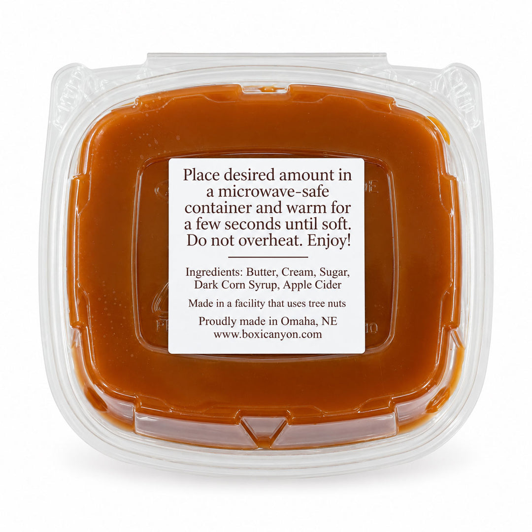 Boxic Canyon Butter Cream Sugar Apple Cider mixture in a clear plastic microwave-safe container with a white label, on a white background.
