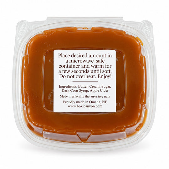 Boxic Canyon Butter Cream Sugar Apple Cider mixture in a clear plastic microwave-safe container with a white label, on a white background.