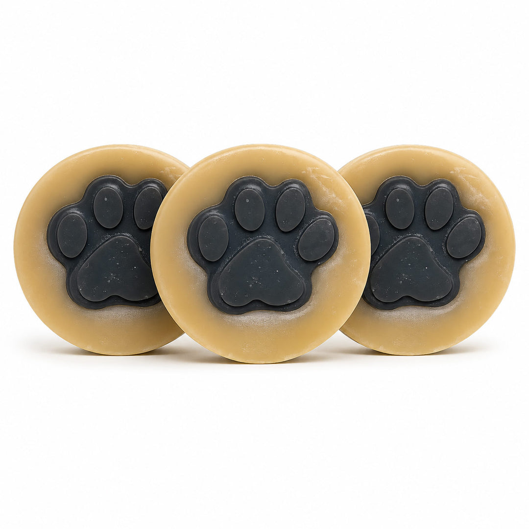 Three beige circular objects with black paw prints on a white background