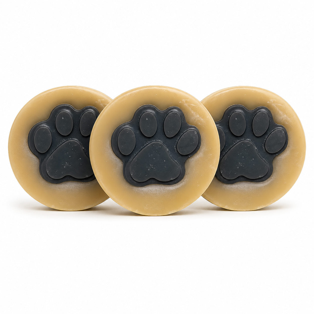 Three beige circular objects with black paw prints on a white background