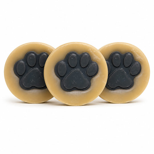 Three beige circular objects with black paw prints on a white background